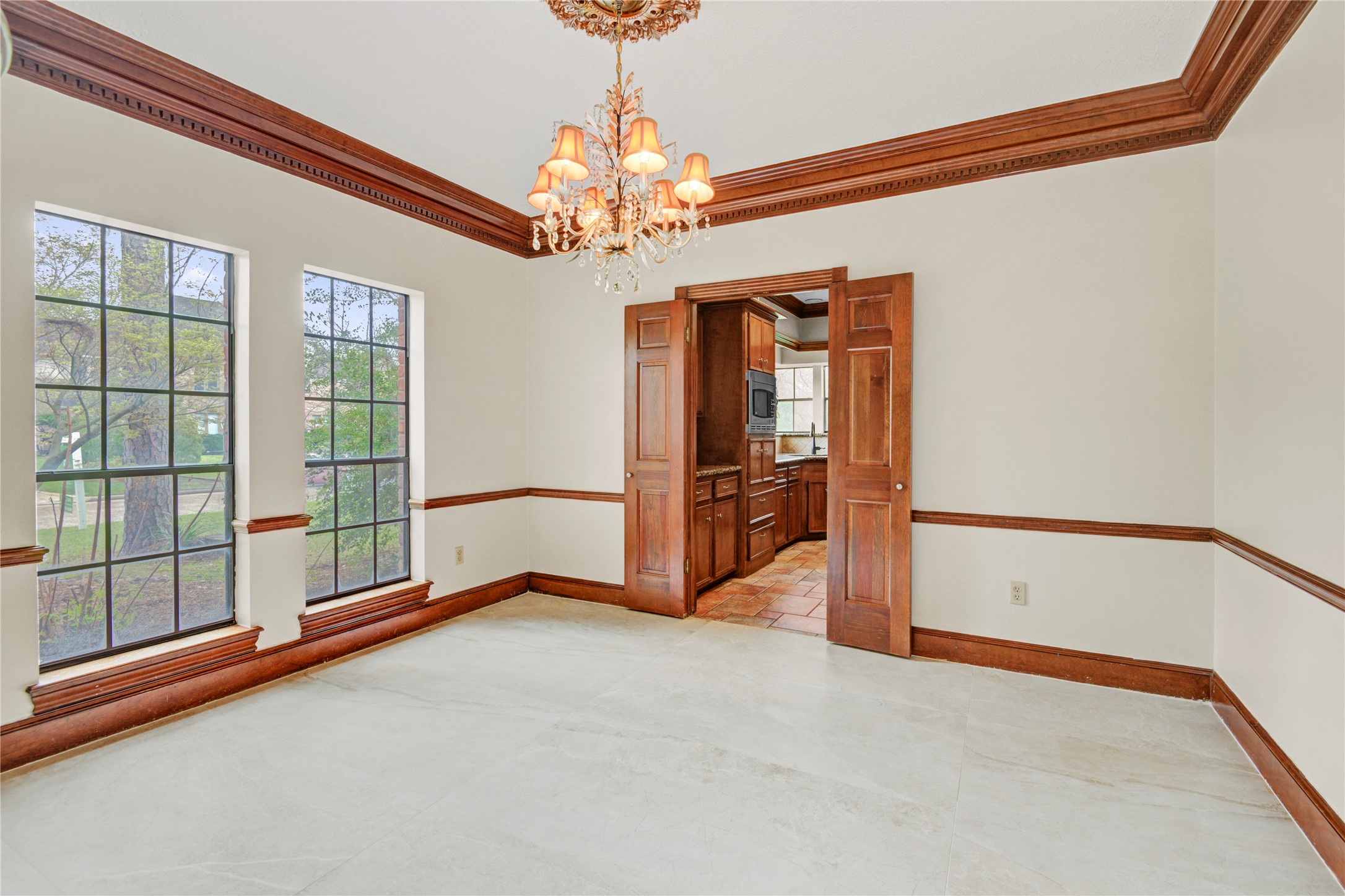8412 Hidden Trail Lane Spring, TX 77379 - Photo 11 of 43 The elegant formal dining room offers crown molding, chair rail detailing, and large windows that fill the space with natural light.
