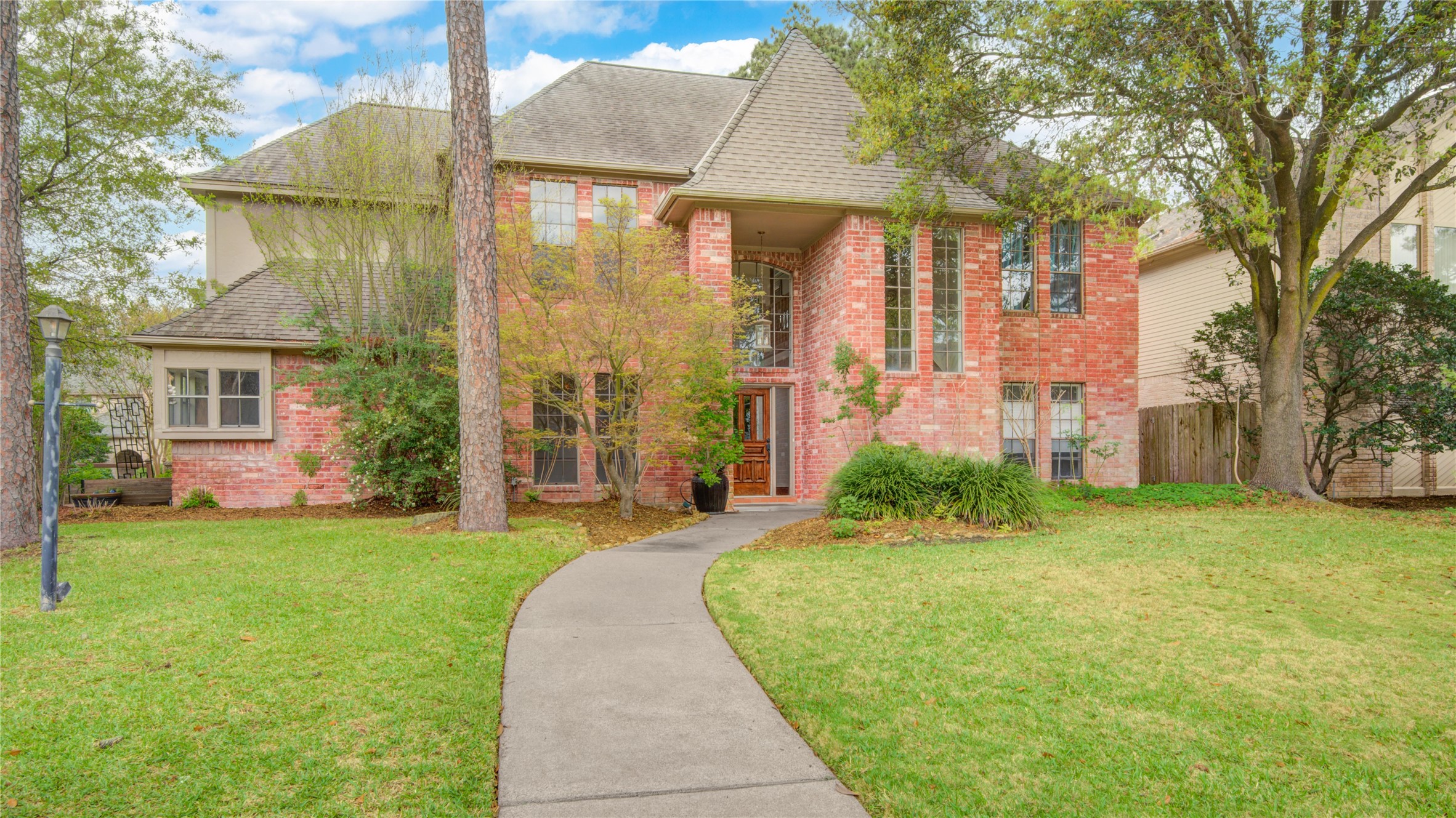8412 Hidden Trail Lane Spring, TX 77379 - Photo 2 of 43 A closer view of the front façade highlights the mature trees and inviting approach to this well-maintained home with pool and spa.