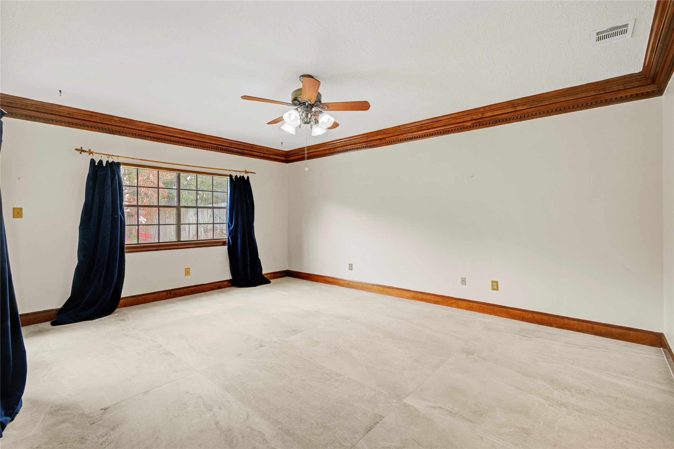 8412 Hidden Trail Lane Spring, TX 77379 - Photo 23 of 43 The spacious first-floor primary bedroom features tray ceilings, soft natural light, and ample room for a relaxing retreat.