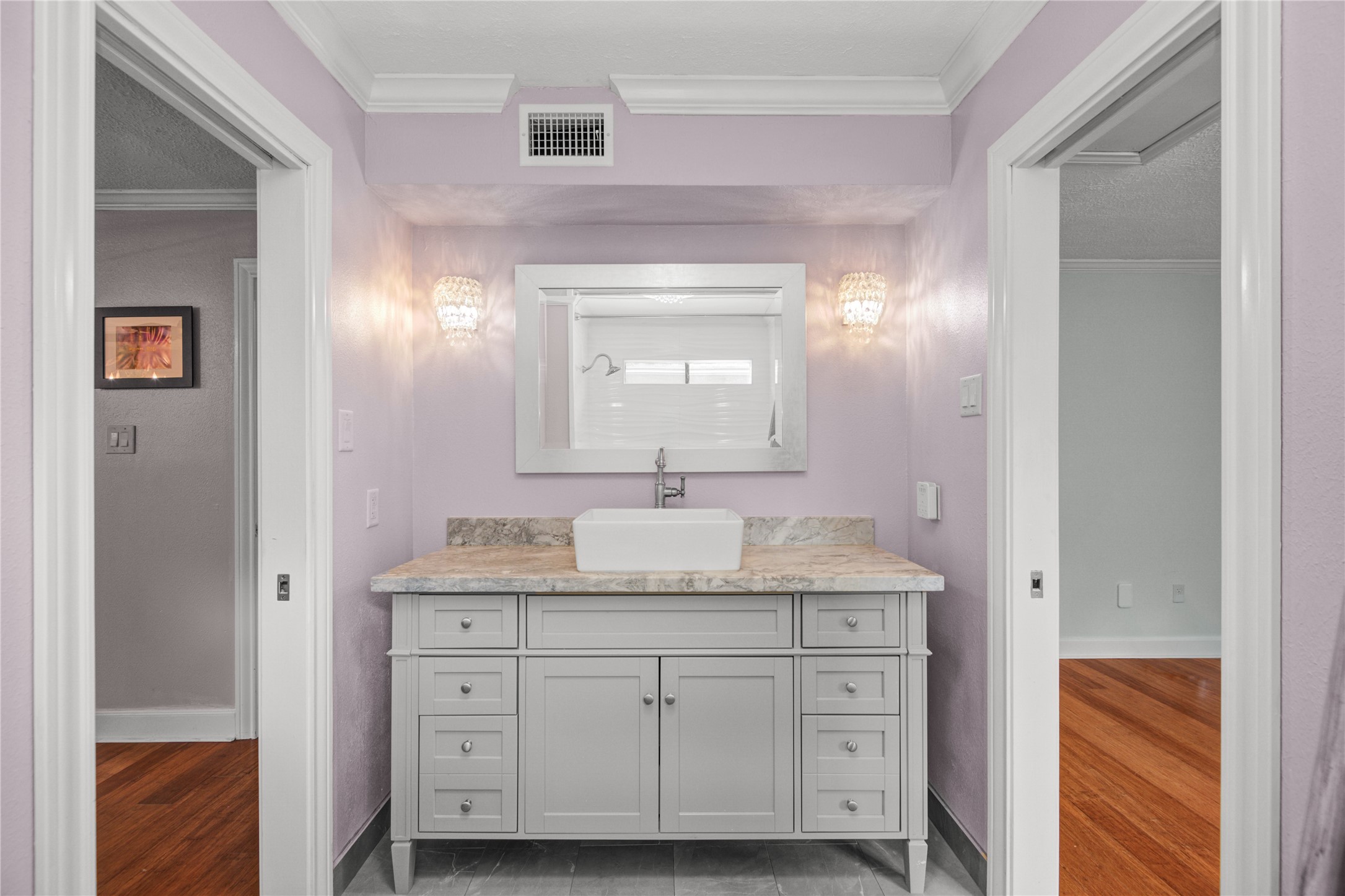 8412 Hidden Trail Lane Spring, TX 77379 - Photo 26 of 39 A stylish vanity with an elegant mirror and lighting provides ample space for daily routines within the shared Jack and Jill bath.