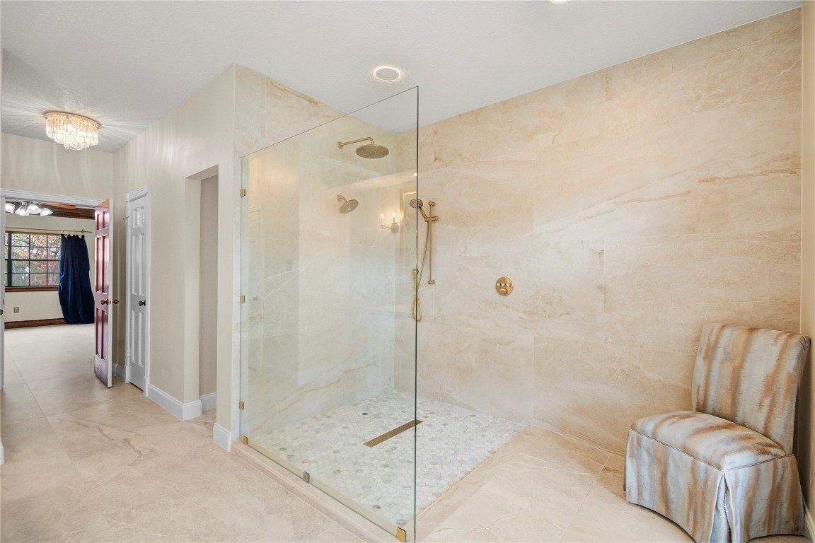 8412 Hidden Trail Lane Spring, TX 77379 - Photo 27 of 43 This view of the spa-inspired primary shower highlights the luxurious oversized design, elegant tilework, and glass enclosure that create a true retreat experience.