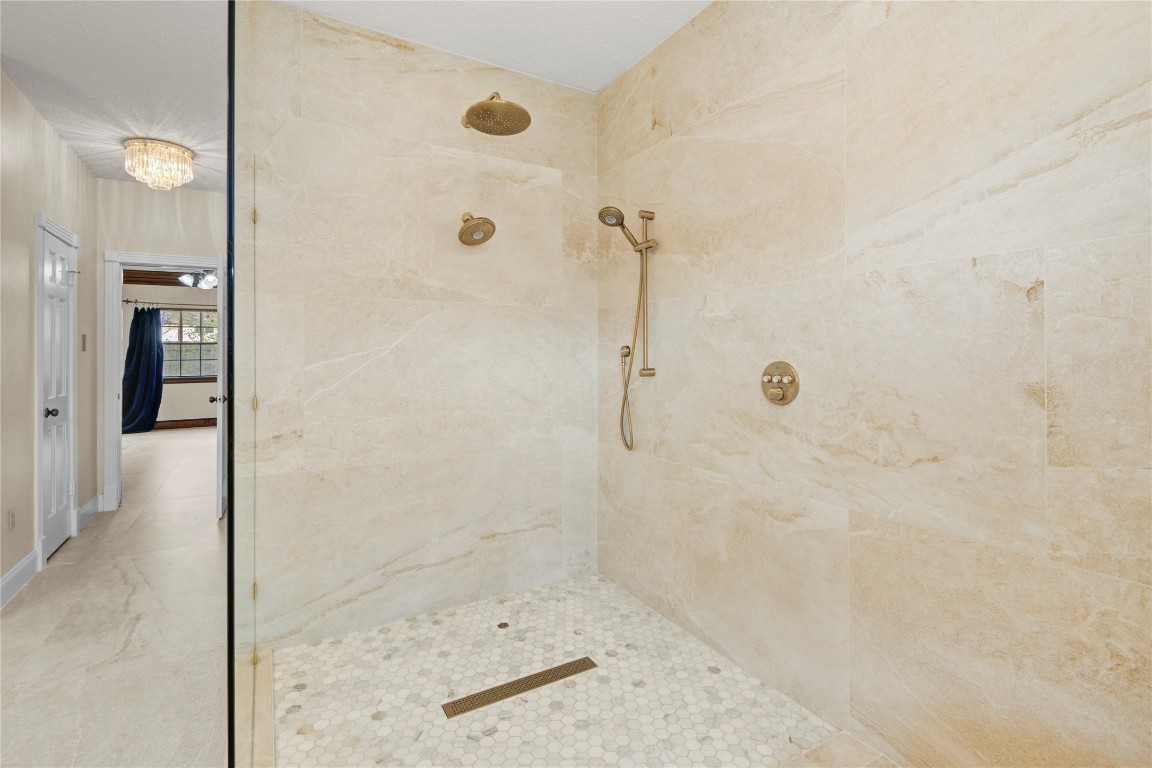 8412 Hidden Trail Lane Spring, TX 77379 - Photo 28 of 43 The spa-like walk-in shower features stunning tilework, multiple shower heads, and a luxurious oversized design for a true retreat experience.