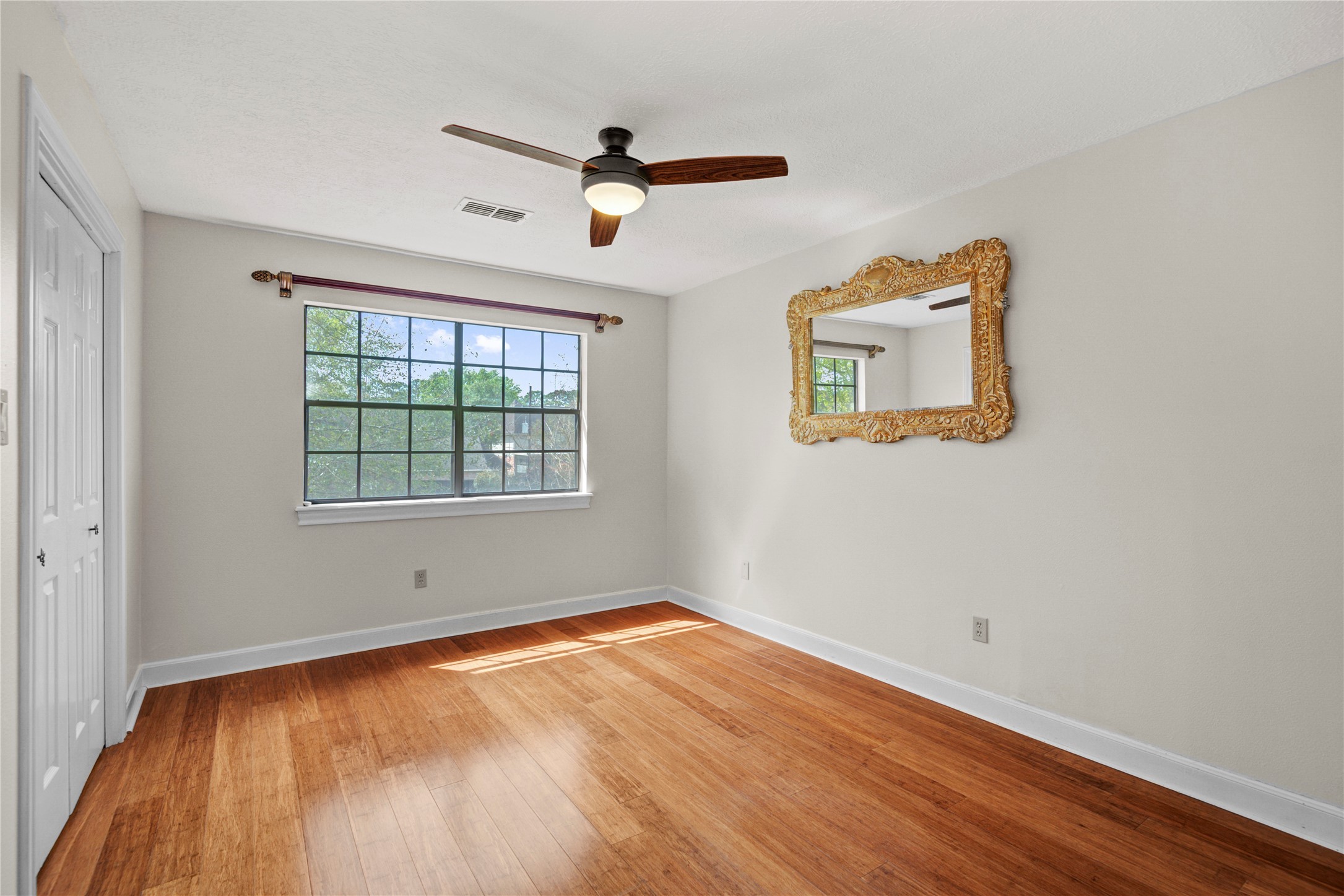 8412 Hidden Trail Lane Spring, TX 77379 - Photo 34 of 43 Another spacious upstairs bedroom offers warm wood flooring, soft natural light, and comfortable accommodations for family or guests.
