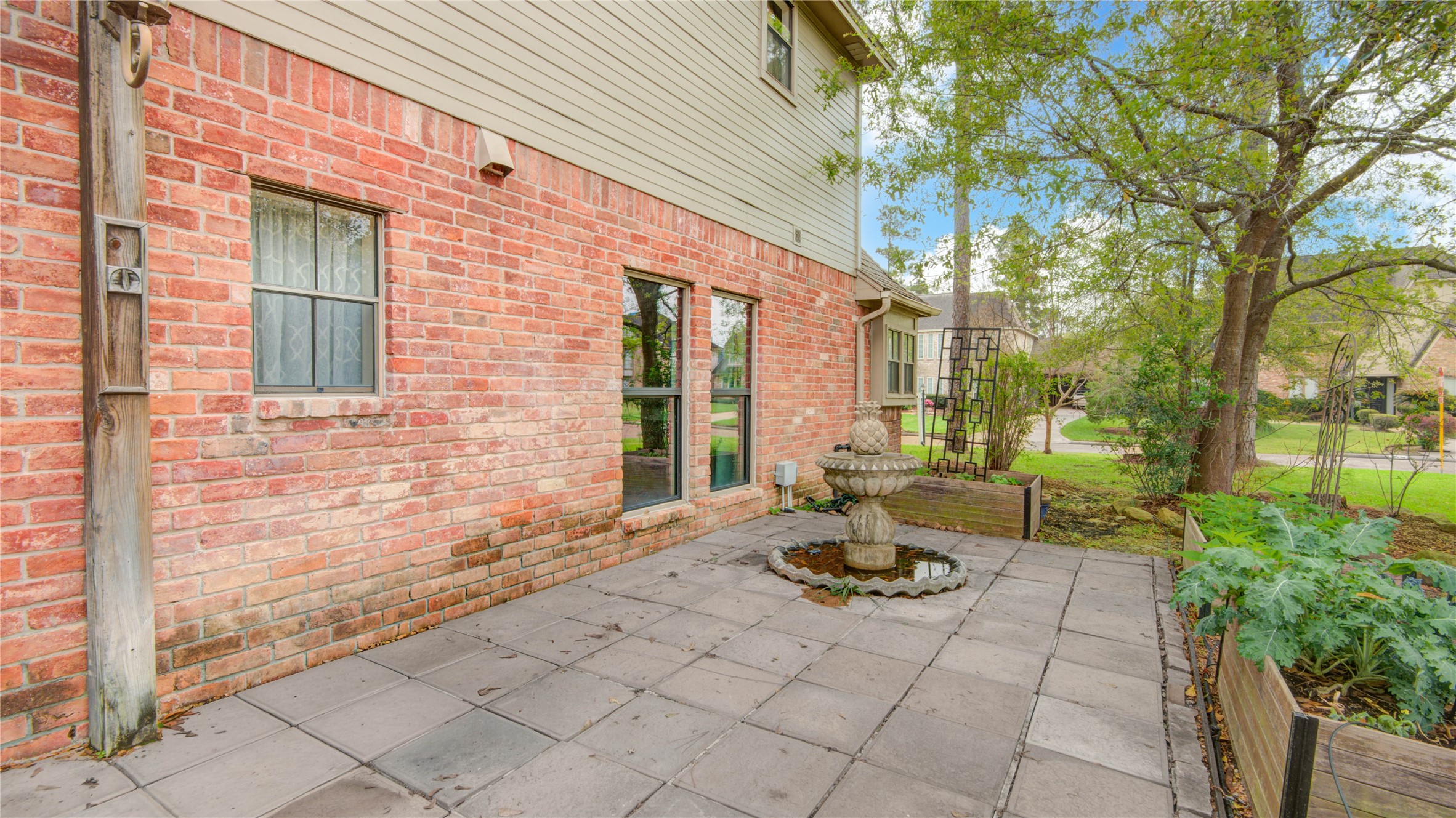 8412 Hidden Trail Lane Spring, TX 77379 - Photo 7 of 43 The spacious brick patio extends along the side of the home, offering a peaceful setting that leads toward the pool and spa area.