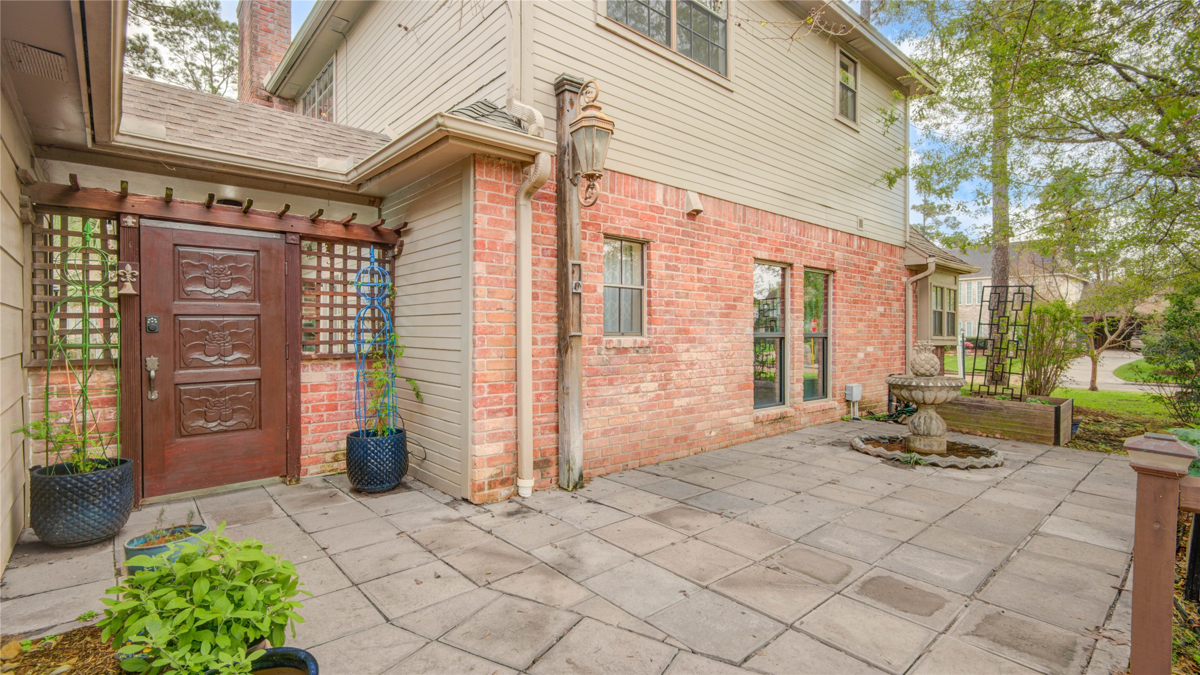8412 Hidden Trail Lane Spring, TX 77379 - Photo 9 of 43 Brick-lined walkways guide you along the home toward the backyard oasis while offering a quiet spot to unwind beside the fountain.