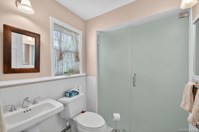 69 Smith Hill Road Airmont, NY 10952 - Photo 17 of 35 a bathroom with a sink mirror and toilet