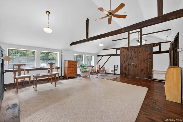a living room with furniture a window and a ceiling fan