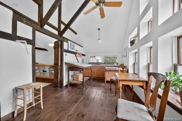 a living room with furniture and a dining table