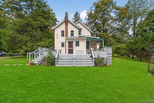 69 Smith Hill Road Airmont, NY 10952 - Photo 4 of 35 a front view of a house with a garden