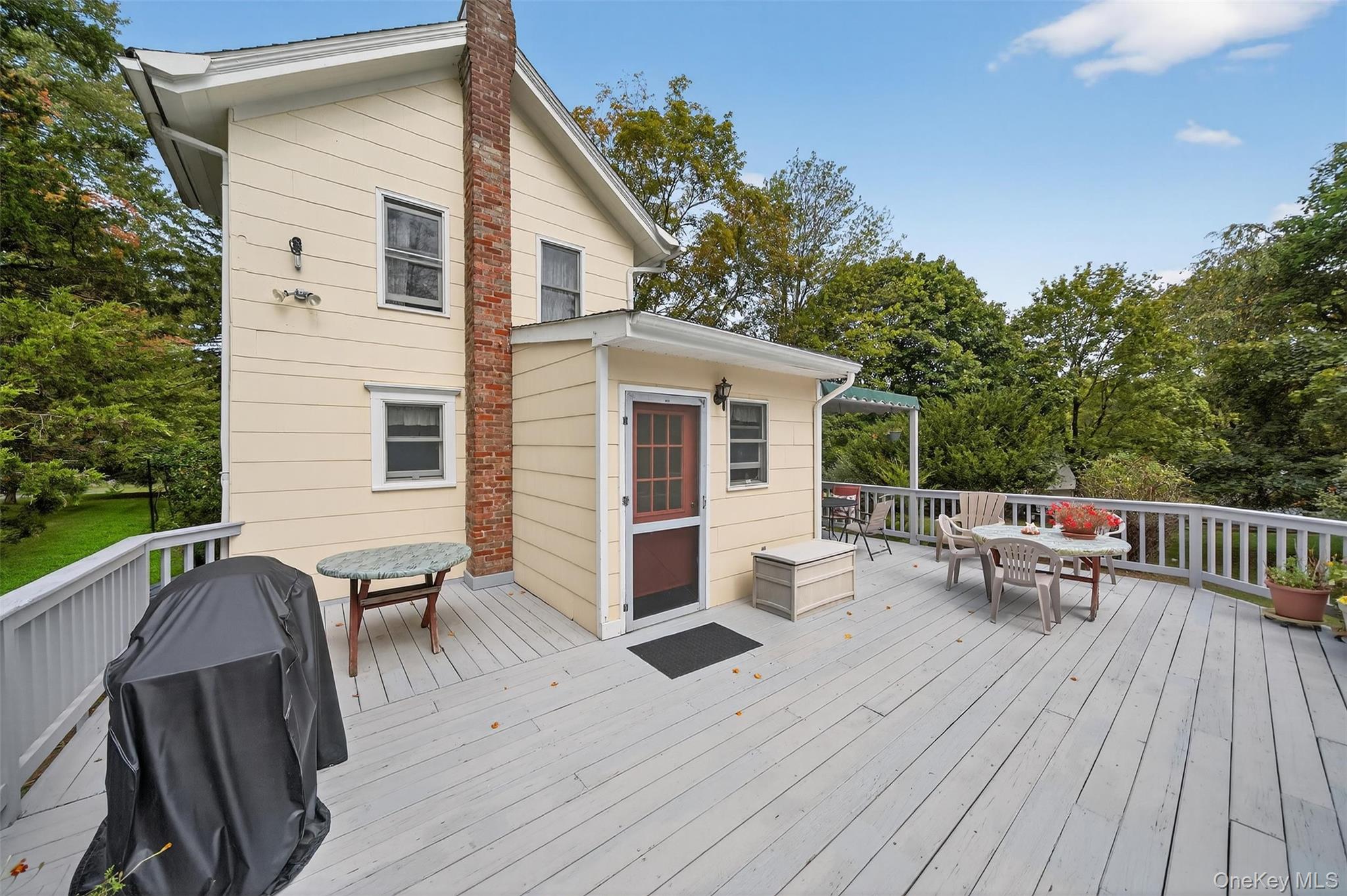 69 Smith Hill Road Airmont, NY 10952 - Photo 6 of 35 a view of a patio with couches table and chairs and potted plants