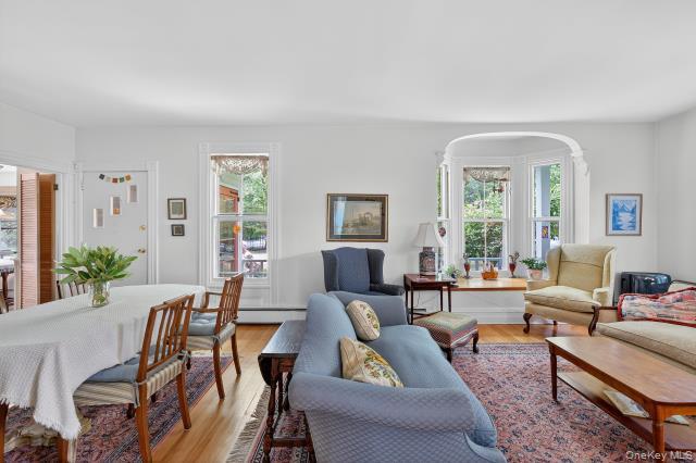 69 Smith Hill Road Airmont, NY 10952 - Photo 10 of 35 a living room with furniture wooden floor and a large window