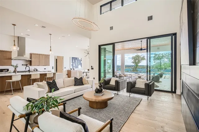 a living room with furniture potted plant and a large window