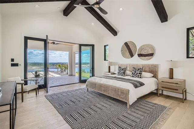 a bedroom with a large bed and a large window