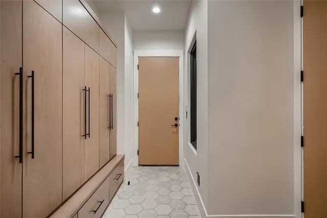 a view of a hallway with wooden floor