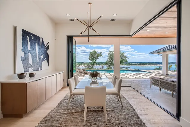 a dining room with wooden floor wooden floor and a chandelier