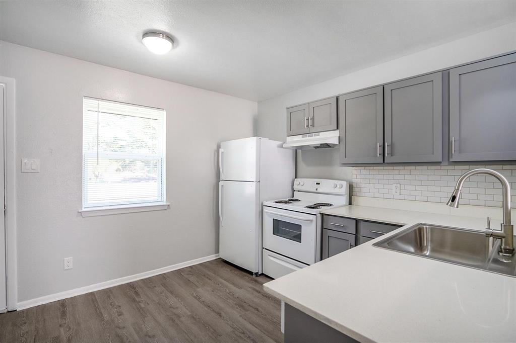 307 Rose Street, Unit 311C Arlington, TX 76010 - Photo 3 of 10 a kitchen with a sink a stove a refrigerator and cabinets