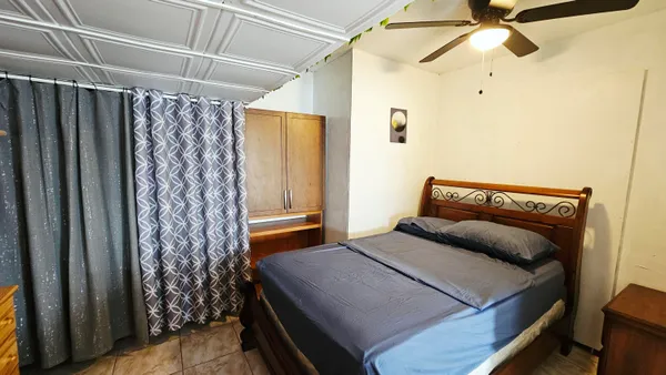 a bedroom with a bed and a window