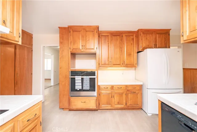 a kitchen with a refrigerator and a stove