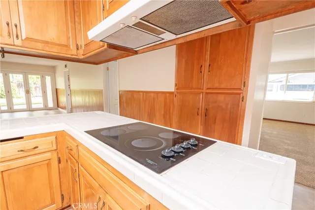 a kitchen with a stove and a refrigerator