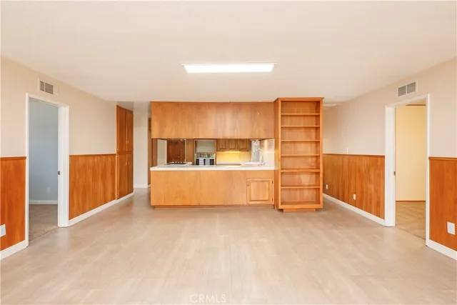 a view of kitchen with furniture and a refrigerator