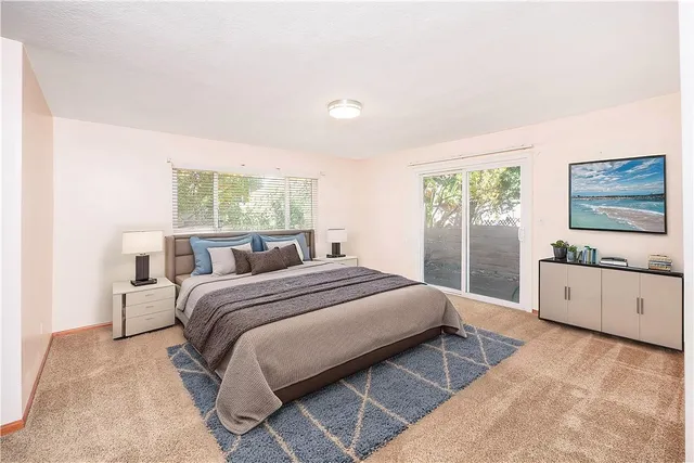 a large bedroom with a large bed and windows