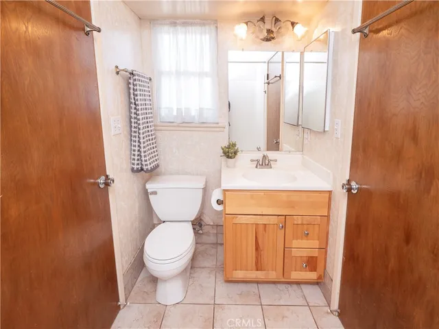 a bathroom with a toilet sink and a mirror