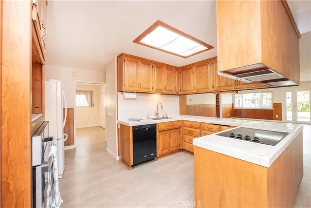 a kitchen that has a sink and a stove