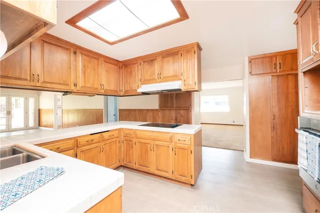 a kitchen with stainless steel appliances granite countertop a sink and a cabinets
