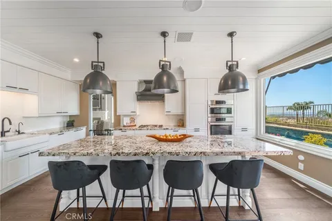 a kitchen with a sink and chairs