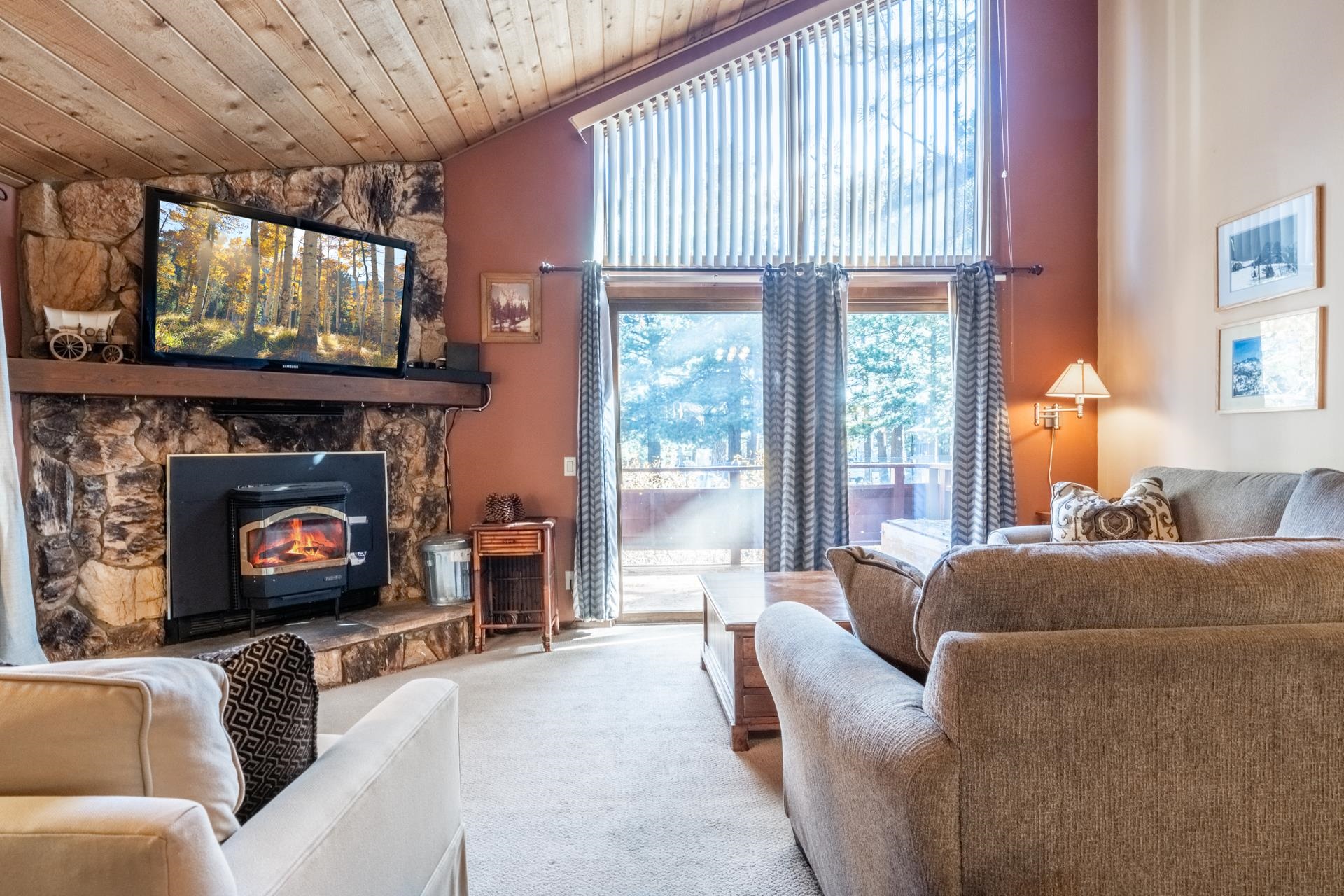 2112 Meridian Boulevard, Unit 7 Mammoth Lakes, CA 93546 - Photo 1 of 33 Carpeted living area featuring high vaulted ceiling and a wood stove