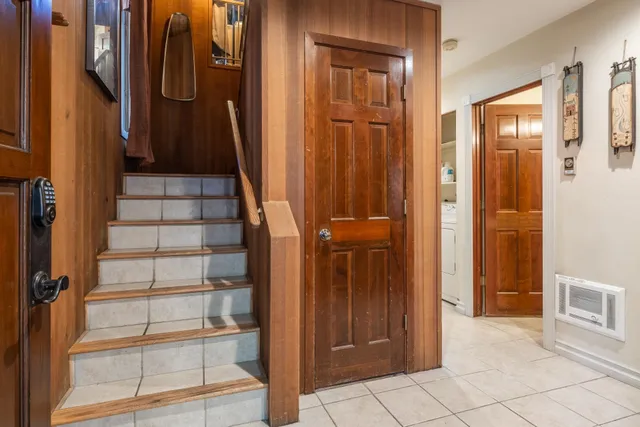 a bedroom with a bed and a dresser next to a window