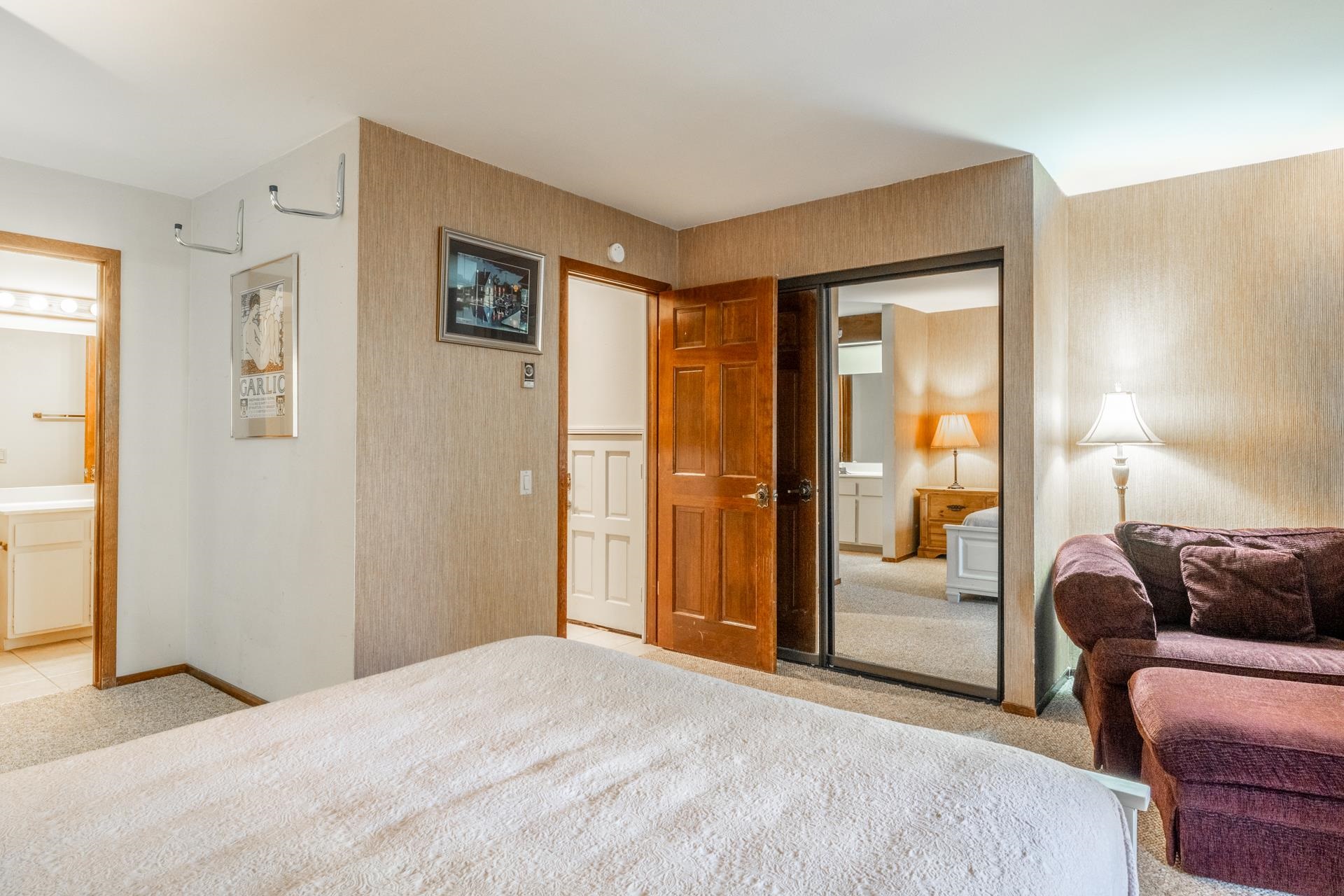 2112 Meridian Boulevard, Unit 7 Mammoth Lakes, CA 93546 - Photo 21 of 33 Bedroom with a closet, light colored carpet, wallpapered walls, and ensuite bathroom