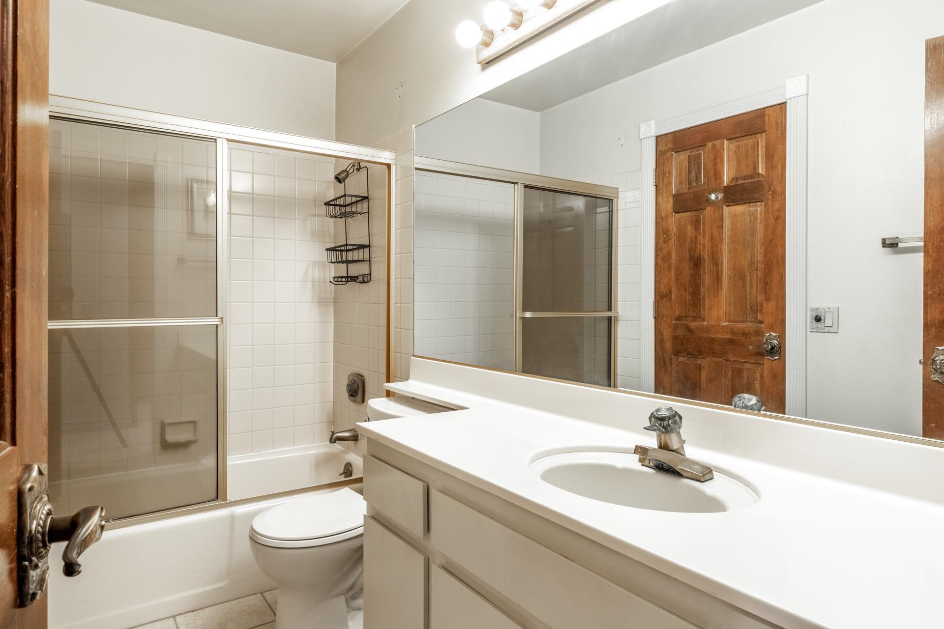2112 Meridian Boulevard, Unit 7 Mammoth Lakes, CA 93546 - Photo 23 of 33 Bathroom featuring vanity, combined bath / shower with glass door, and light tile patterned flooring