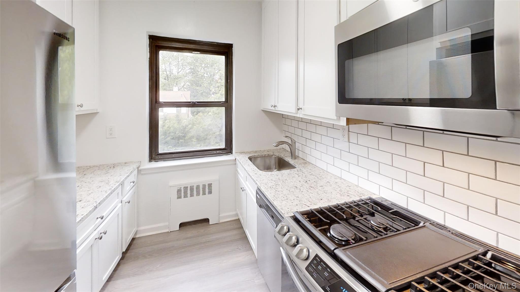 50 White Oak Street, Unit 4B New Rochelle, NY 10801 - Photo 15 of 20 a kitchen with granite countertop a sink and a stove