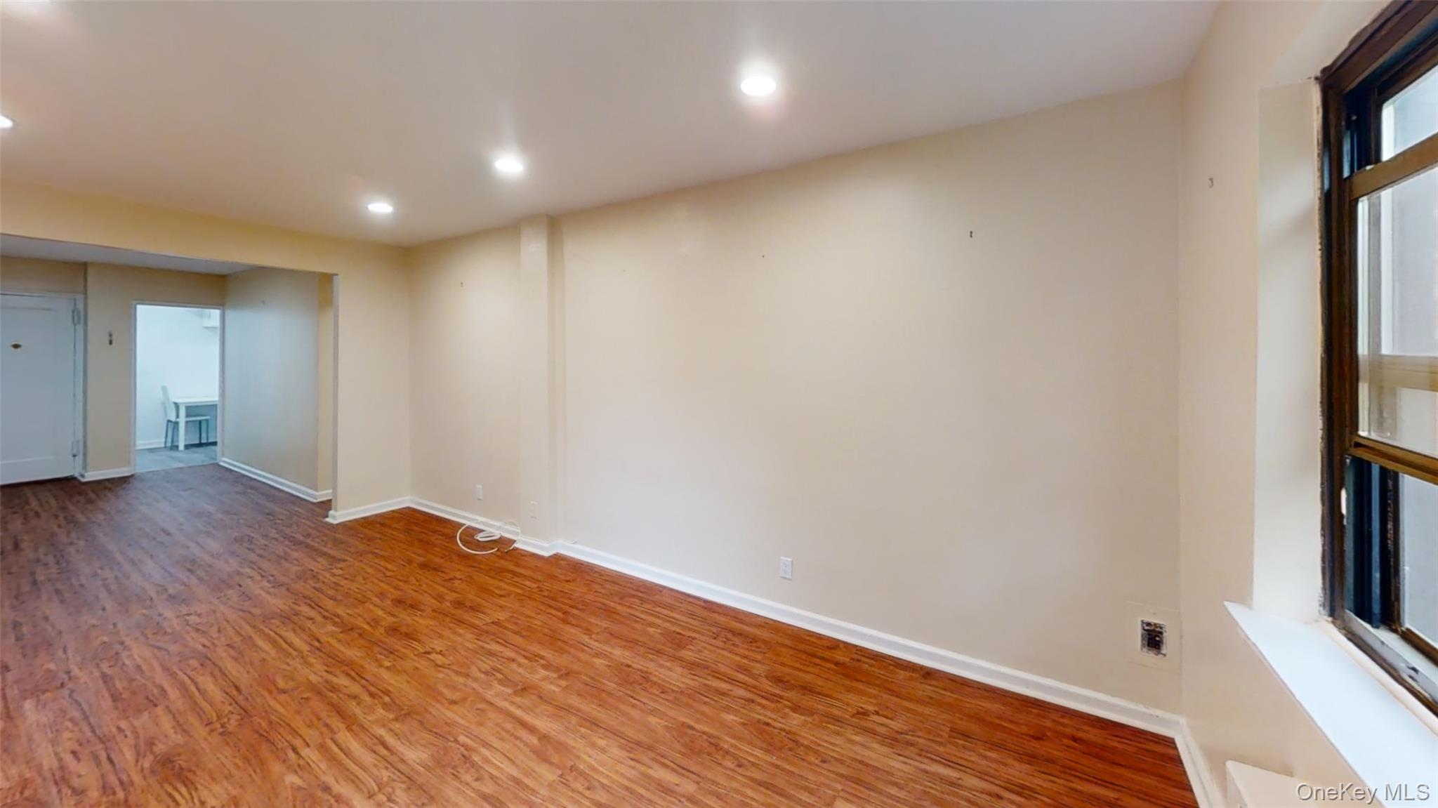 50 White Oak Street, Unit 4B New Rochelle, NY 10801 - Photo 4 of 20 a view of empty room with wooden floor and fan
