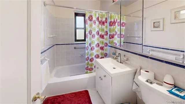 a bathroom with a sink a toilet and shower curtain