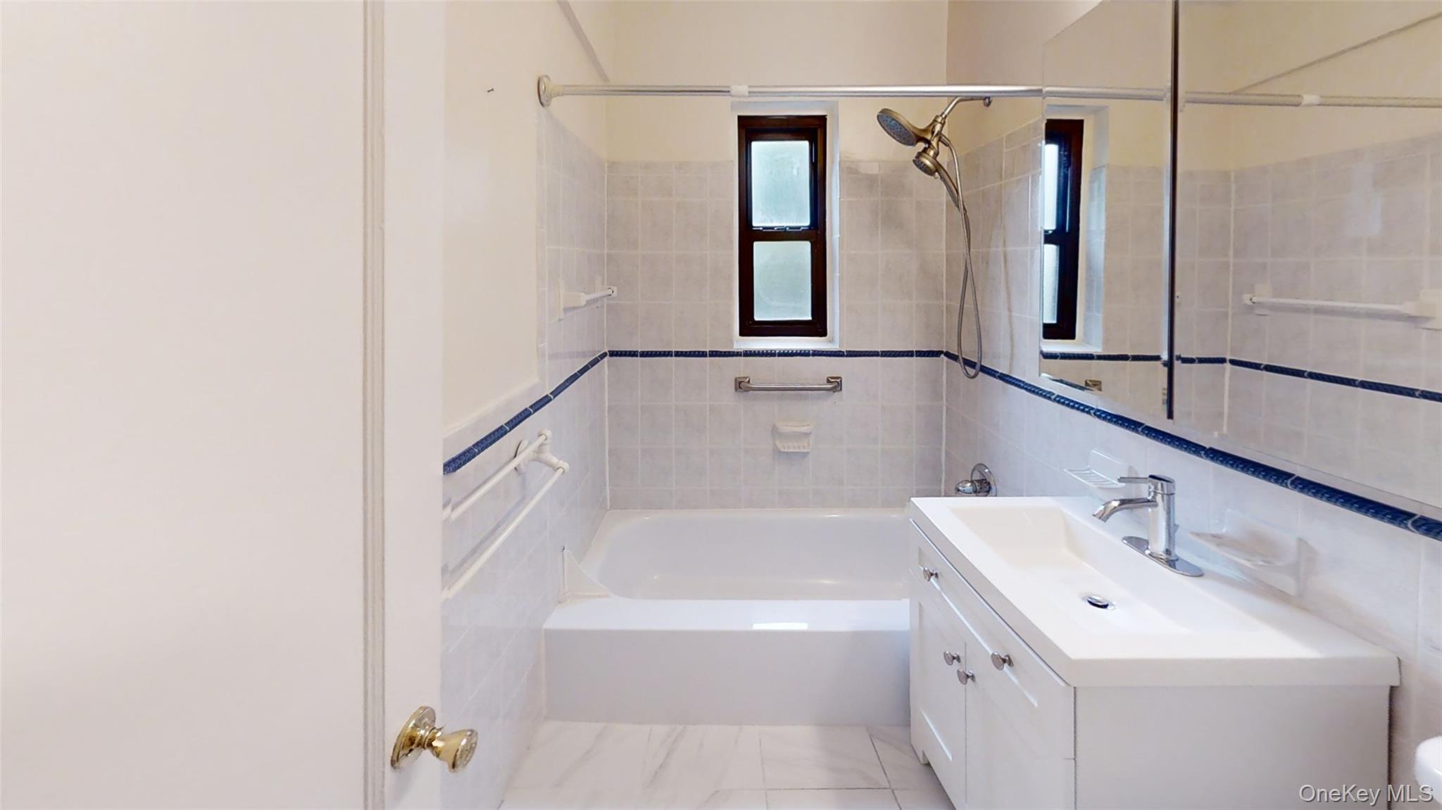 50 White Oak Street, Unit 4B New Rochelle, NY 10801 - Photo 8 of 20 a bathroom with a tub sink and mirror