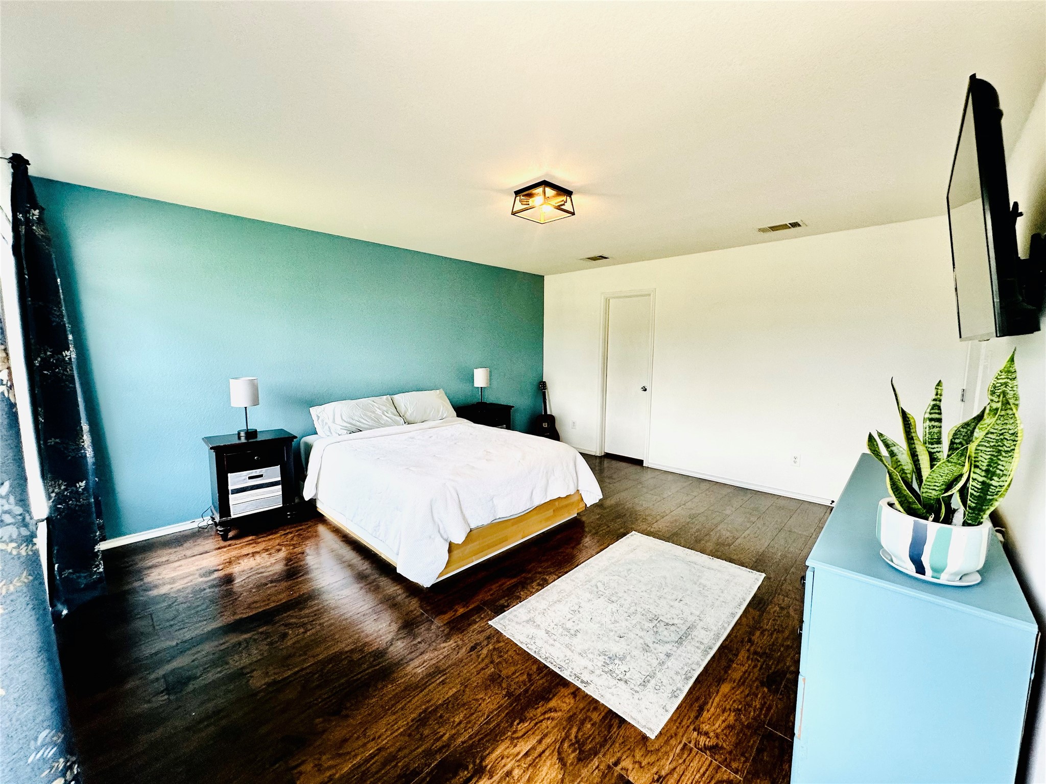 602 Lavaca Loop Elgin, TX 78621 - Photo 12 of 28 a bedroom with a bed and wooden floor