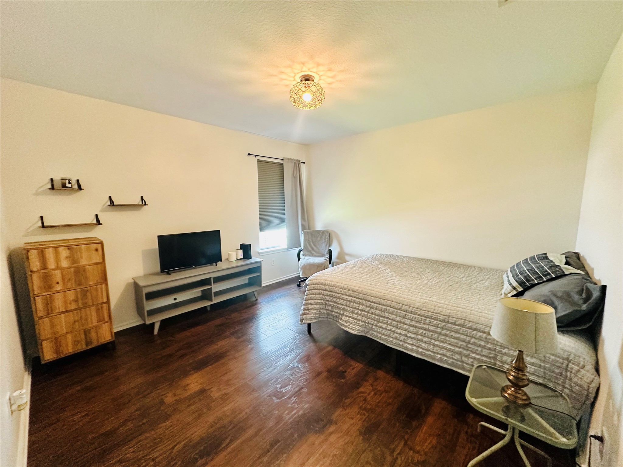 602 Lavaca Loop Elgin, TX 78621 - Photo 16 of 28 a bedroom with a bed and wooden floor