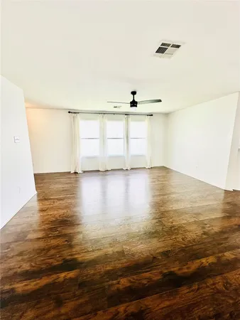 a view of a room with wooden floor