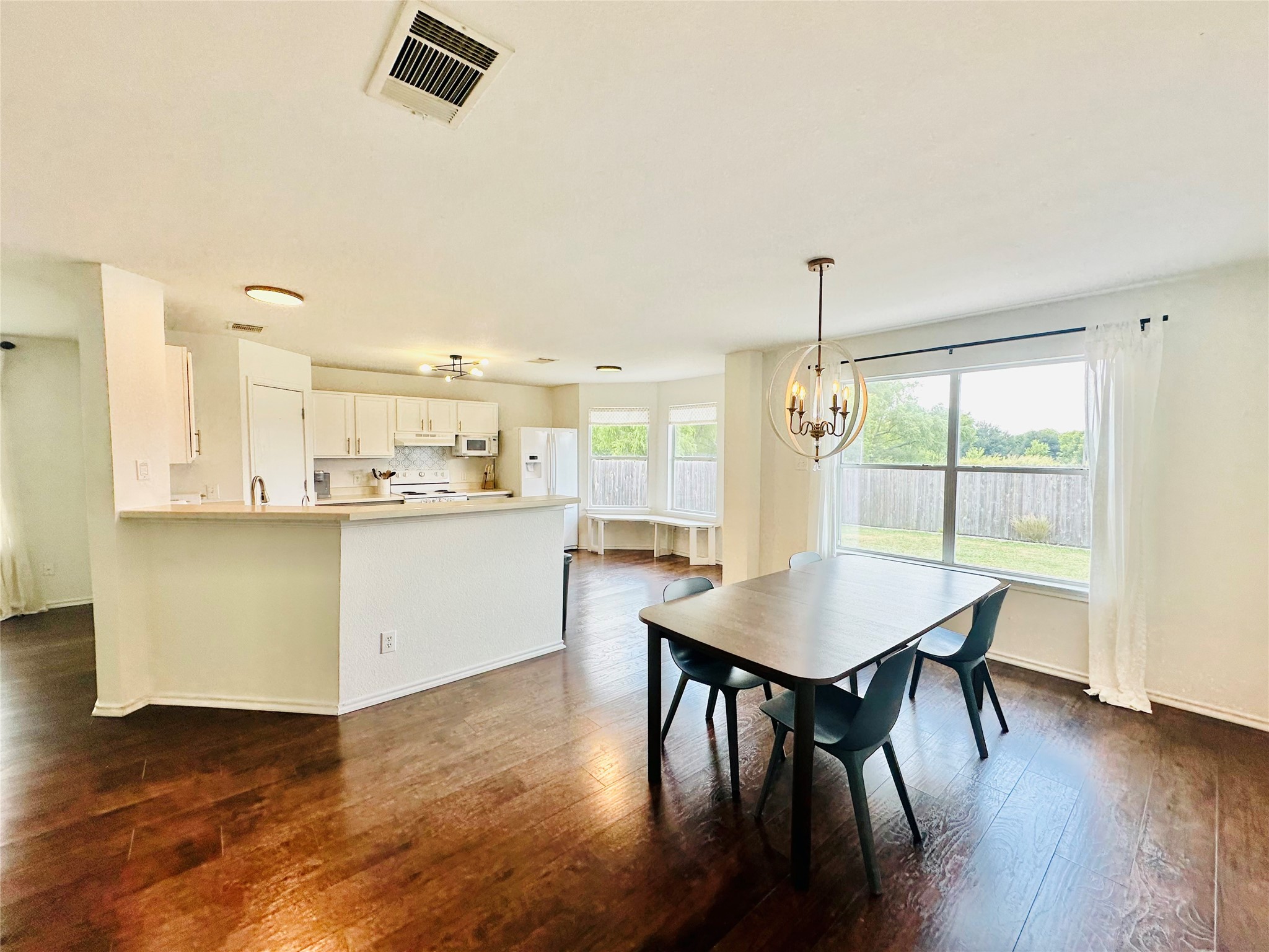 602 Lavaca Loop Elgin, TX 78621 - Photo 8 of 28 a room with a table chairs and a kitchen