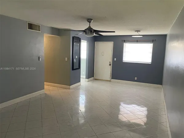 a view of an empty room with a window