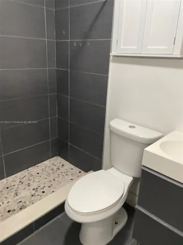 a white toilet sitting next to a bathroom sink
