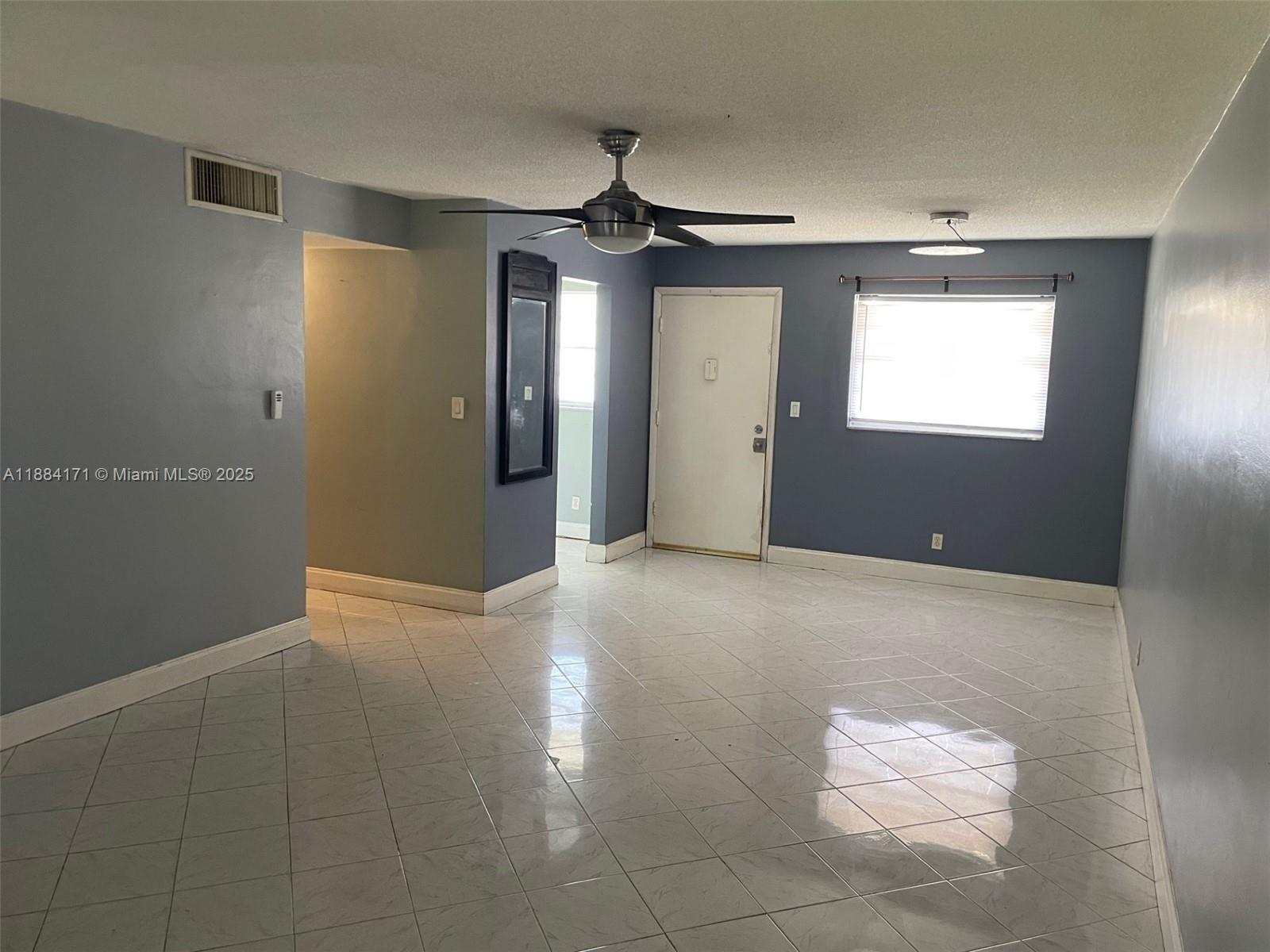 20201 Northeast 29th Court, Unit D112 Aventura, FL 33180 - Photo 3 of 17 a view of an empty room with a window
