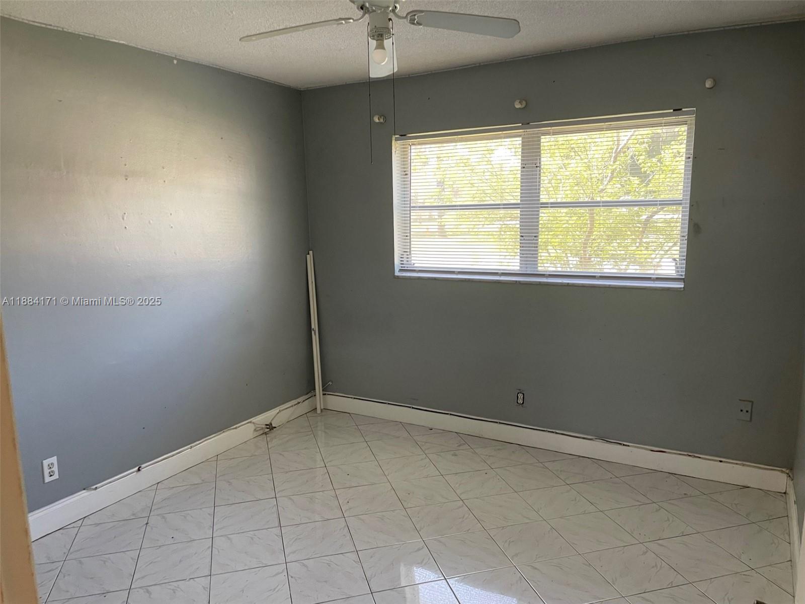 20201 Northeast 29th Court, Unit D112 Aventura, FL 33180 - Photo 4 of 17 an empty room with a window