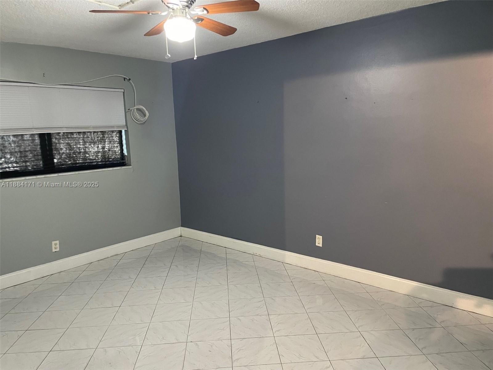 20201 Northeast 29th Court, Unit D112 Aventura, FL 33180 - Photo 5 of 17 a view of an empty room with chandelier fan