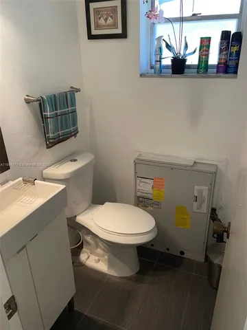 a white toilet sitting next to a bathroom sink