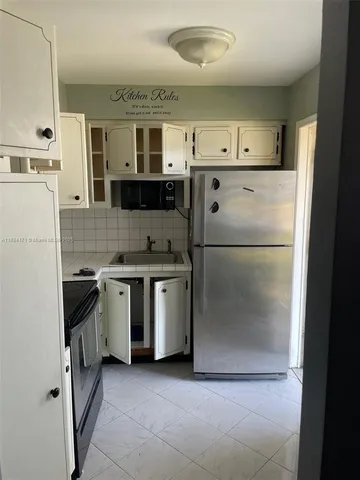 a kitchen with a refrigerator and a stove