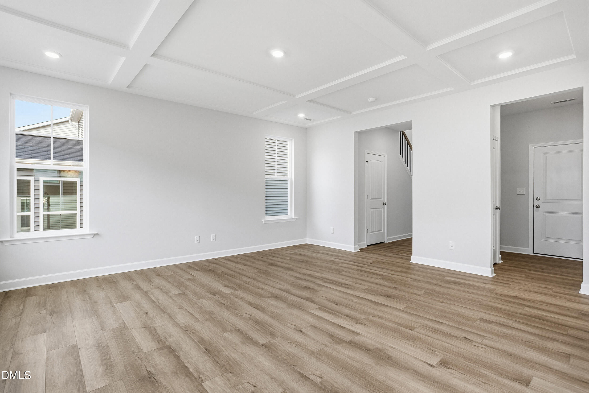 288 Meadowbark Bend, Unit 37 Garner, NC 27529 - Photo 9 of 50 an empty room with wooden floor and windows