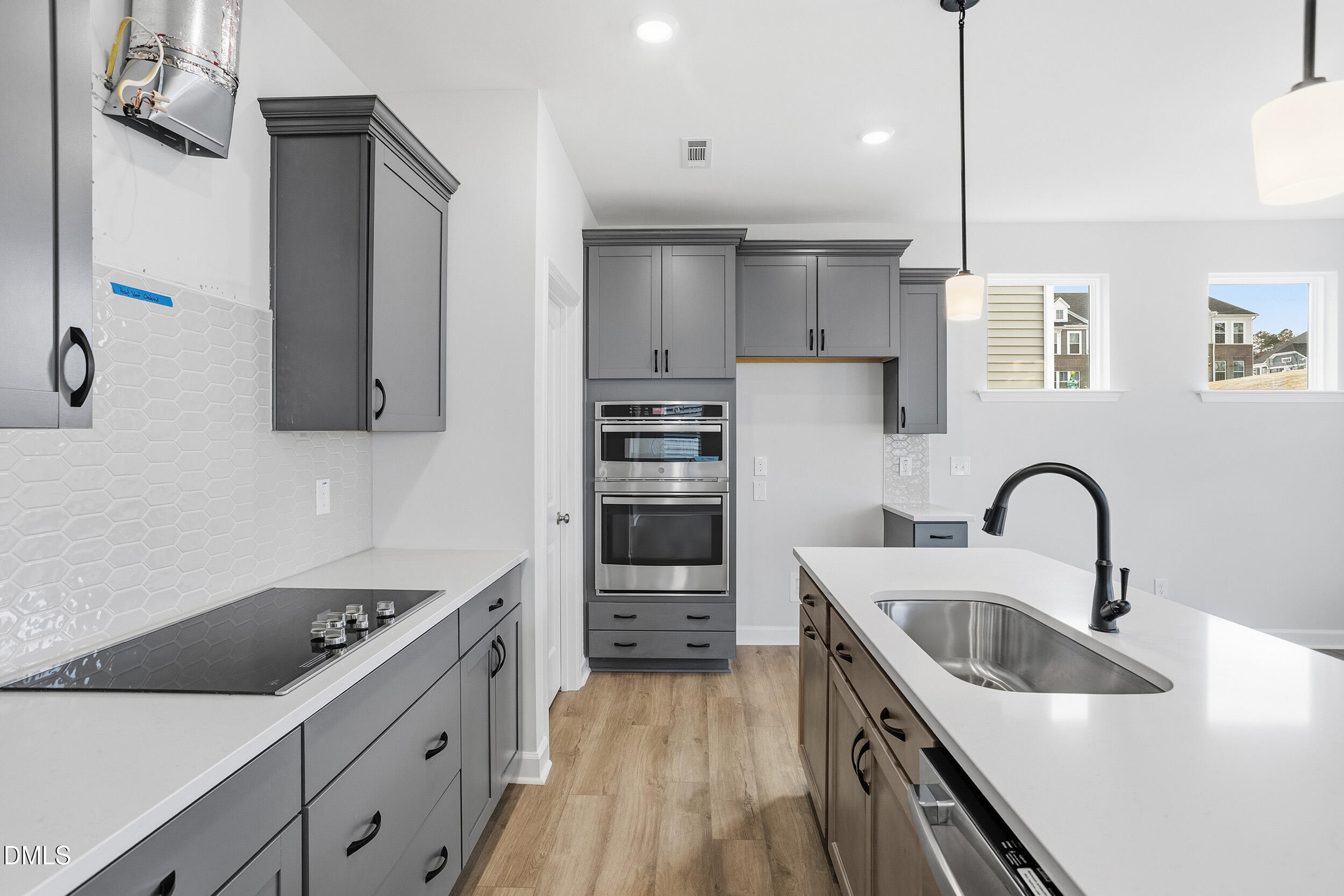 288 Meadowbark Bend, Unit 37 Garner, NC 27529 - Photo 13 of 50 a kitchen with kitchen island stainless steel appliances a sink a stove and refrigerator